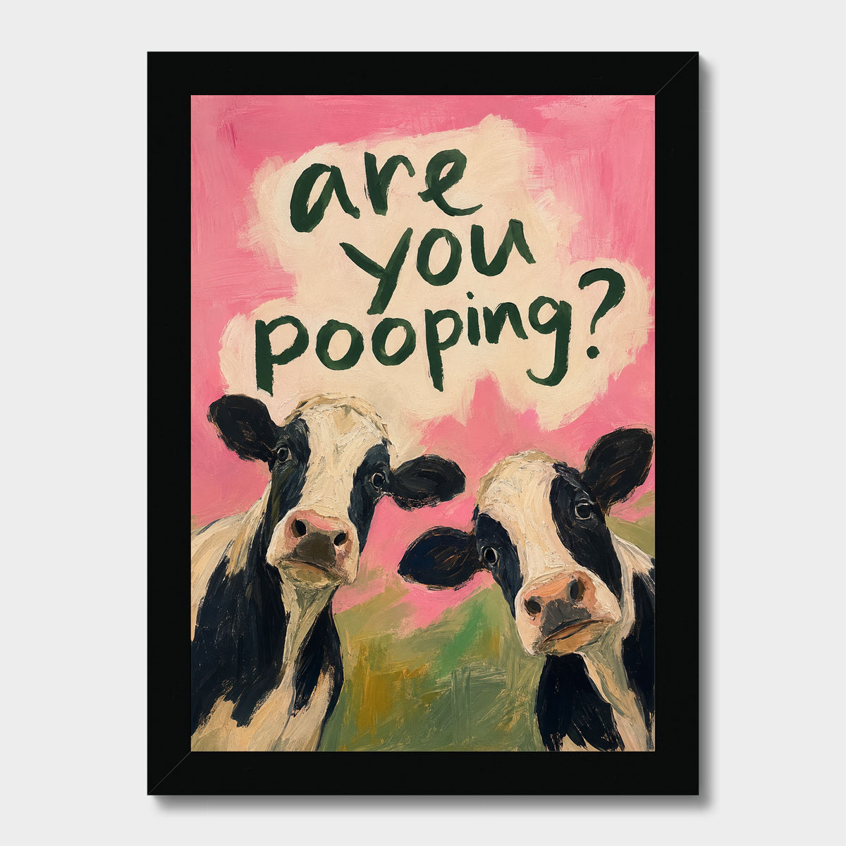 A framed art print featuring two black-and-white cows against a pink background with the text 'are you pooping?' in dark green lettering. The print is enclosed in a black frame and shown against a light gray background.