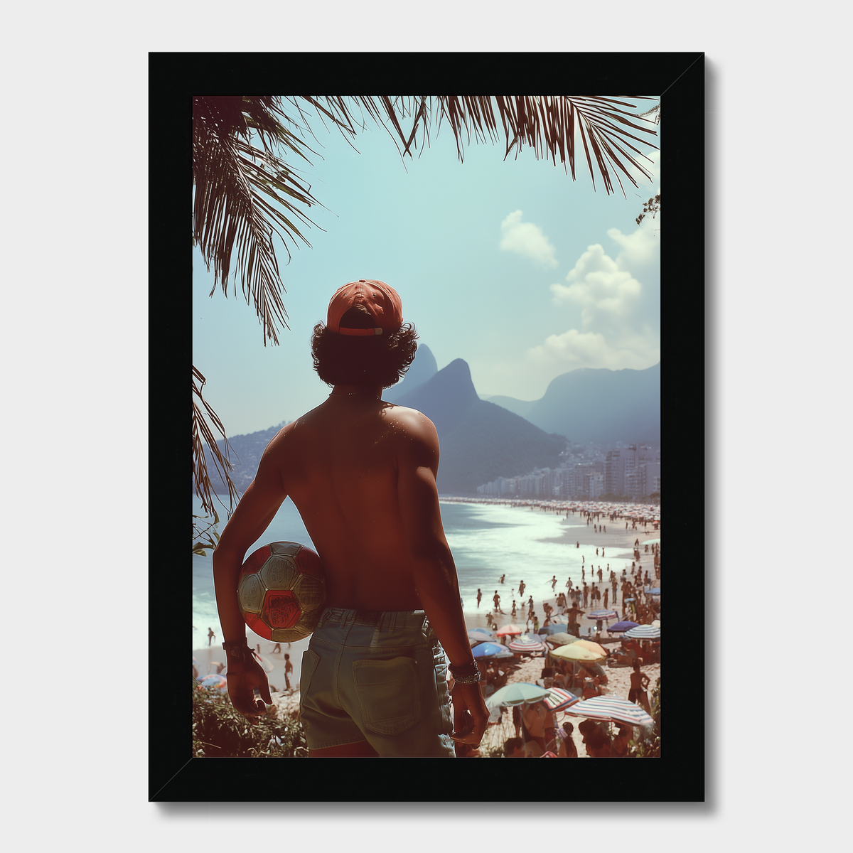 Man on a beach holding a surfboard with palm trees and mountains in the background