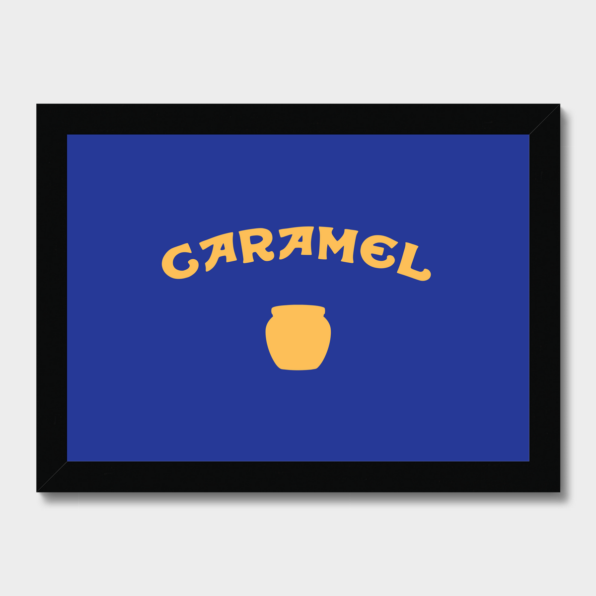 A framed square wall art print featuring a royal blue background with the word 'CARAMEL' in yellow arched lettering and a yellow jar icon below, shown on a light gray background.
