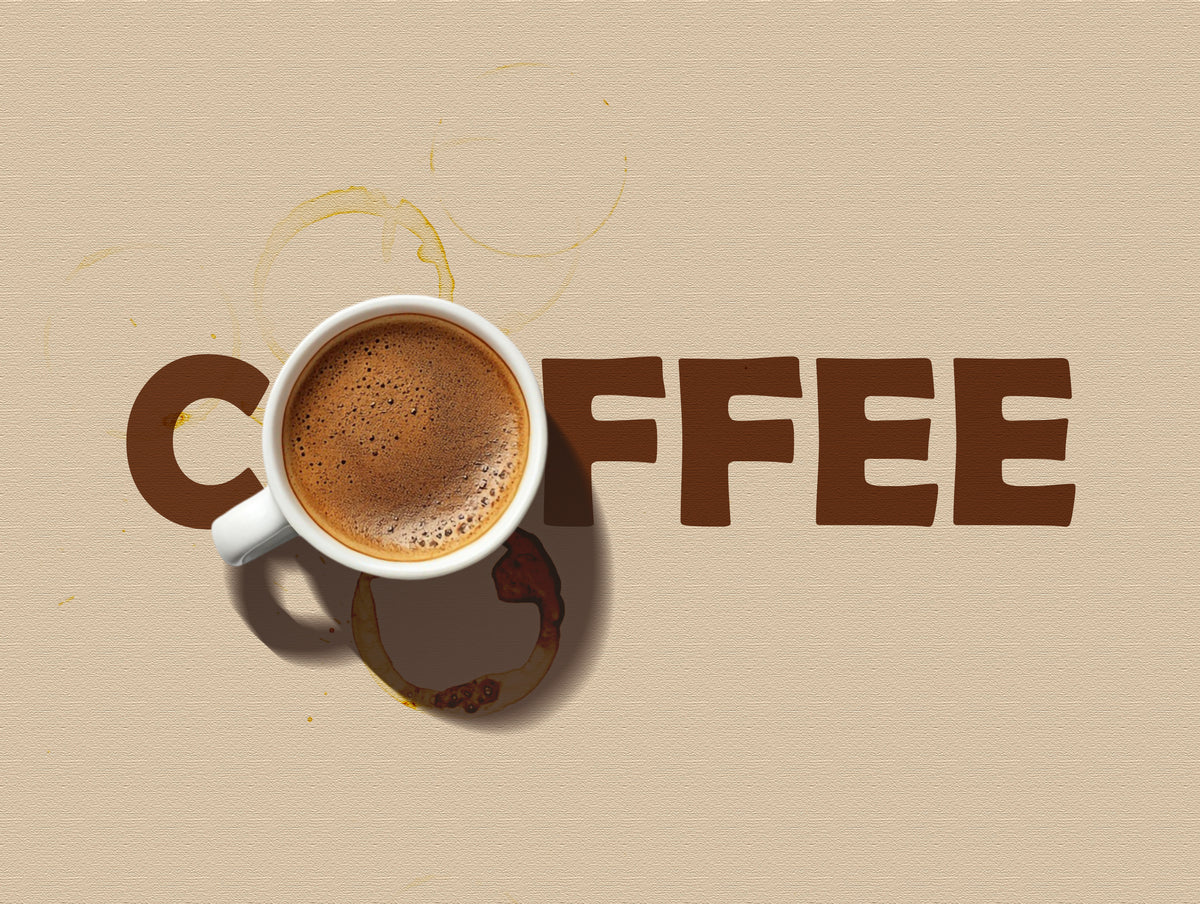 A white ceramic coffee mug filled with espresso sits on a beige textured background next to large brown letters spelling COFFEE, with coffee-ring stains above and below the cup.