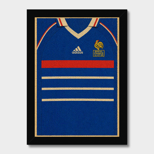 A framed wall art print featuring a stylized blue France soccer jersey with gold trim, a red chest stripe, and white Adidas branding, shown against a light gray background.