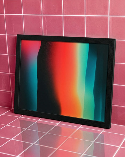A framed abstract art print with vertical gradient stripes in red, orange, teal, and black, set in a black frame against a pink tiled wall.