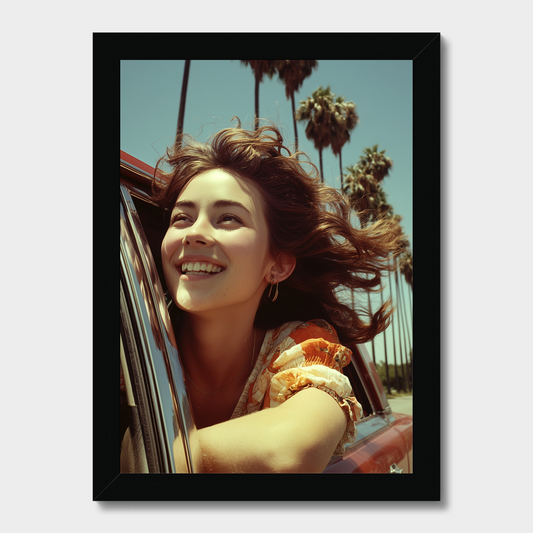 Woman with long brown hair leaning out of a car window with palm trees in the background