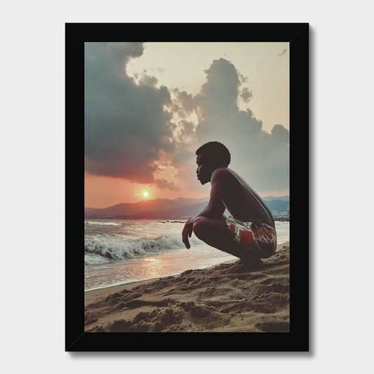 Person sitting on a beach at sunset with dramatic clouds